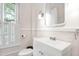 This bathroom has a white sink and white walls with a window at 3521 Banks Rd, Raleigh, NC 27603