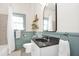 This bathroom features a modern sink, toilet, and a large window at 3521 Banks Rd, Raleigh, NC 27603
