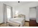 Cozy bedroom with wood floors and a bench at the foot of the bed at 3521 Banks Rd, Raleigh, NC 27603