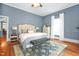 This bedroom features blue wallpaper, hardwood floors, and a bed at 3521 Banks Rd, Raleigh, NC 27603