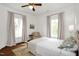 Bedroom with hardwood floors, ceiling fan, and neutral decor at 3521 Banks Rd, Raleigh, NC 27603