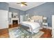 This bedroom features blue wallpaper, hardwood floors, and a brick fireplace at 3521 Banks Rd, Raleigh, NC 27603