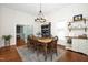 Bright dining room with a wooden dining table, hardwood floors, and modern lighting at 3521 Banks Rd, Raleigh, NC 27603