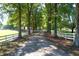 Tree-lined driveway with white fencing leading to a beautiful home at 3521 Banks Rd, Raleigh, NC 27603