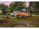 A beautiful white home with pond reflecting the string lights on the covered porch at 3521 Banks Rd, Raleigh, NC 27603
