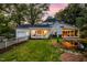 Charming white home with a lush backyard, pond and a pergola covered patio at 3521 Banks Rd, Raleigh, NC 27603