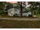 Two-story home with black shutters, manicured landscaping, and mature trees at 3521 Banks Rd, Raleigh, NC 27603