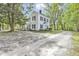 Beautiful white house with black shutters, a welcoming porch, and a gravel driveway at 3521 Banks Rd, Raleigh, NC 27603