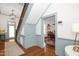 Bright foyer with hardwood floors, a staircase, and stylish wainscotting at 3521 Banks Rd, Raleigh, NC 27603