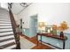 Inviting foyer features hardwood floors, staircase, and stylish decor on a console table at 3521 Banks Rd, Raleigh, NC 27603