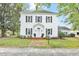 Charming white two-story home featuring black shutters and a brick path leading to the front door at 3521 Banks Rd, Raleigh, NC 27603