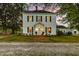 Charming two-story home with black shutters, inviting lighting, and a brick pathway to the front entrance at 3521 Banks Rd, Raleigh, NC 27603