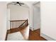 Hallway with hardwood floors and traditional wooden railing at 3521 Banks Rd, Raleigh, NC 27603