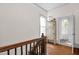 This hallway features hardwood floors, a window, and a view of the bathroom at 3521 Banks Rd, Raleigh, NC 27603