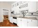 Kitchen features granite countertops, modern appliances, white cabinetry, and hardwood floors at 3521 Banks Rd, Raleigh, NC 27603