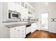 Well-lit kitchen features granite countertops, modern appliances, and white cabinetry at 3521 Banks Rd, Raleigh, NC 27603