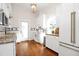 Bright kitchen boasts white cabinets, stainless steel appliances, and hardwood floors at 3521 Banks Rd, Raleigh, NC 27603