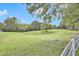 Expansive grassy land featuring scattered trees under a bright blue sky at 3521 Banks Rd, Raleigh, NC 27603