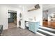 Well-organized laundry room features a stacked washer/dryer, utility sink, and gray tile floors at 3521 Banks Rd, Raleigh, NC 27603