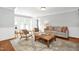 Comfortable living room featuring hardwood floors, a soft color palette, and cozy seating arrangements at 3521 Banks Rd, Raleigh, NC 27603