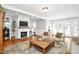Inviting living room features hardwood floors, a fireplace with a TV, and French doors that allow ample natural light at 3521 Banks Rd, Raleigh, NC 27603