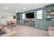 Cozy living room with built-in shelving, entertainment center, and carpet flooring at 3521 Banks Rd, Raleigh, NC 27603