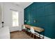 Office space with paneled accent wall, built in desk and plenty of natural light at 3521 Banks Rd, Raleigh, NC 27603