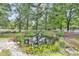 Scenic pond with a waterfall, lush plants, and reflections of surrounding trees creating a tranquil scene at 3521 Banks Rd, Raleigh, NC 27603