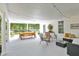 Bright and spacious porch with ample seating, decorative accents, and a peaceful outdoor view at 3521 Banks Rd, Raleigh, NC 27603