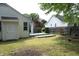 Backyard with a wooden deck, well-kept lawn, and mature trees at 3521 Piedmont Dr, Raleigh, NC 27604