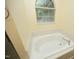 Bathroom featuring large tub and picture window at 3521 Piedmont Dr, Raleigh, NC 27604