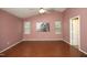 Spacious bedroom with hardwood floors, ceiling fan, and picture window at 3521 Piedmont Dr, Raleigh, NC 27604