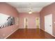 Bedroom featuring hardwood floors, ceiling fan, and two closets at 3521 Piedmont Dr, Raleigh, NC 27604