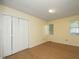 Bright bedroom with hardwood floors, a closet, and windows providing natural light at 3521 Piedmont Dr, Raleigh, NC 27604
