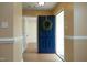 Inviting foyer with wood floors and a bright blue front door adorned with a green wreath at 3521 Piedmont Dr, Raleigh, NC 27604
