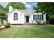 Charming one-story home featuring a well-manicured lawn, blue shutters, and a lovely front door at 3521 Piedmont Dr, Raleigh, NC 27604
