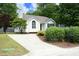 Well-maintained home with landscaped front yard, a driveway, and mature trees offering shade at 3521 Piedmont Dr, Raleigh, NC 27604