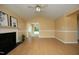 Bright living room with a fireplace, smooth floors and open access to an adjacent room at 3521 Piedmont Dr, Raleigh, NC 27604