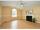 Comfortable living room featuring a fireplace, large window with plenty of natural light, and ceiling fan at 3521 Piedmont Dr, Raleigh, NC 27604