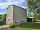 View of a barn exterior, showcasing its classic design and sturdy structure surrounded by lush greenery at 3785 Little Creek Church Rd, Clayton, NC 27520