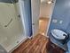 Stylish bathroom features a shower and a sink with wood look floors at 3785 Little Creek Church Rd, Clayton, NC 27520