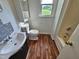 Well-lit bathroom with modern fixtures and wood floors and white tiling at 3785 Little Creek Church Rd, Clayton, NC 27520
