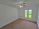 Bedroom features carpeted floors, ceiling fan, and a large window letting in natural light at 3785 Little Creek Church Rd, Clayton, NC 27520