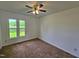 Spacious bedroom features carpeted floors, ceiling fan, and a large window at 3785 Little Creek Church Rd, Clayton, NC 27520