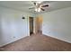 Bedroom boasts carpeted floors, a ceiling fan, and a spacious closet at 3785 Little Creek Church Rd, Clayton, NC 27520