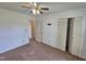Bedroom boasts carpeted floors, a ceiling fan, and a spacious closet at 3785 Little Creek Church Rd, Clayton, NC 27520
