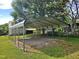 This metal carport provides convenient covered parking space on a gravel lot, blending functionality with outdoor appeal at 3785 Little Creek Church Rd, Clayton, NC 27520