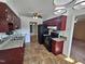 Galley kitchen with tiled floors, warm cabinets, and gas range at 3785 Little Creek Church Rd, Clayton, NC 27520