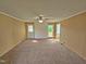 Neutral living room with carpet, paneling, a ceiling fan, and natural light at 3785 Little Creek Church Rd, Clayton, NC 27520