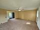 Spacious living room with neutral carpet, classic paneling, and a ceiling fan at 3785 Little Creek Church Rd, Clayton, NC 27520
